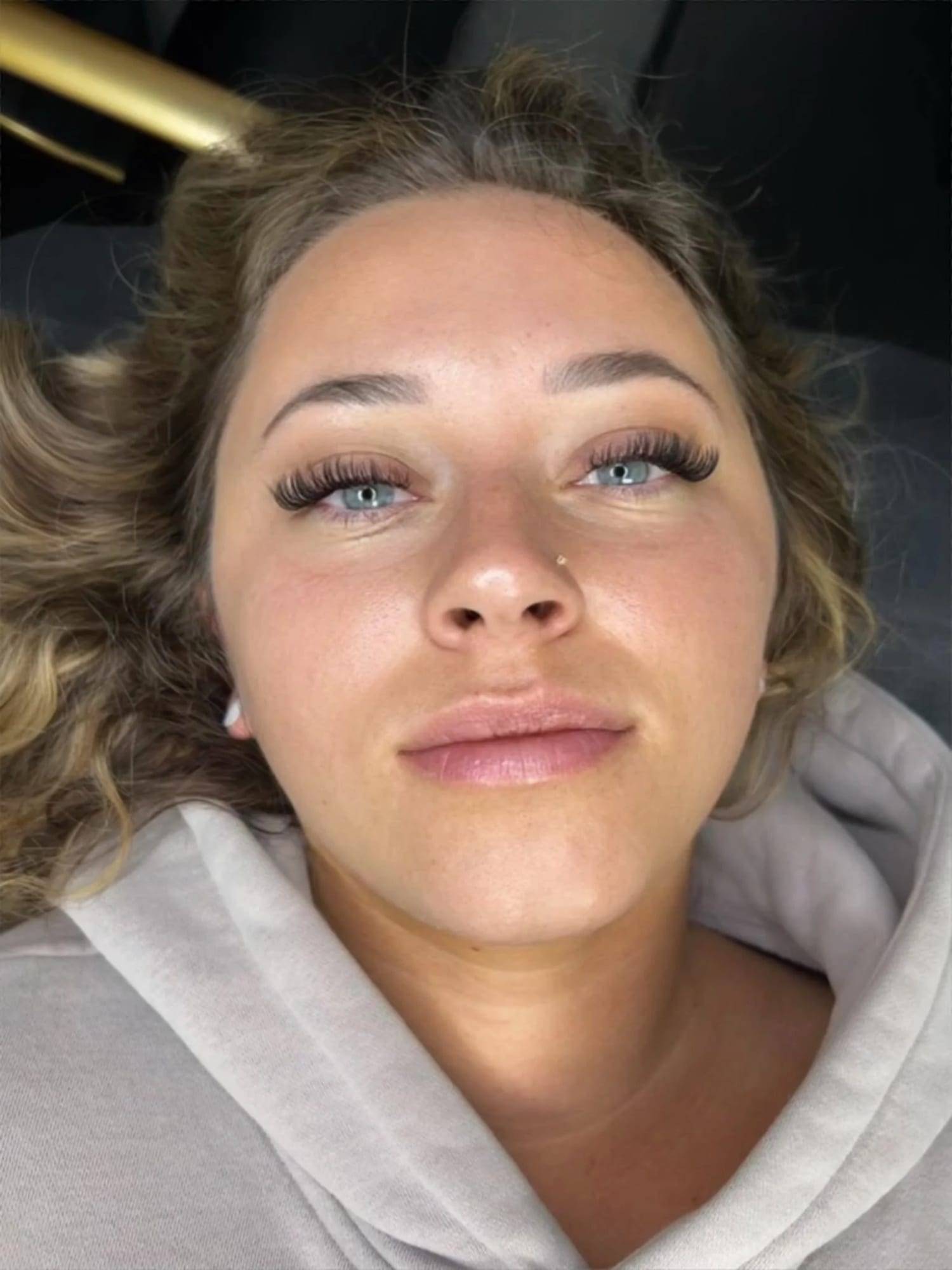 Full, wispy lash extension set on a client with light brown hair