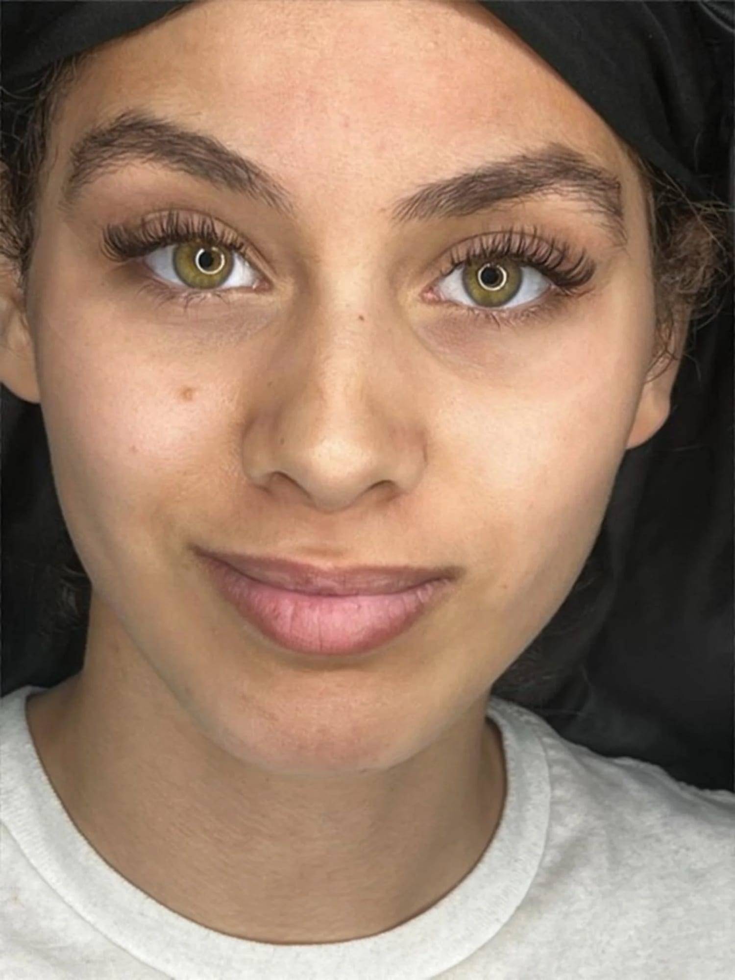 Soft, natural lash extensions framing hazel eyes