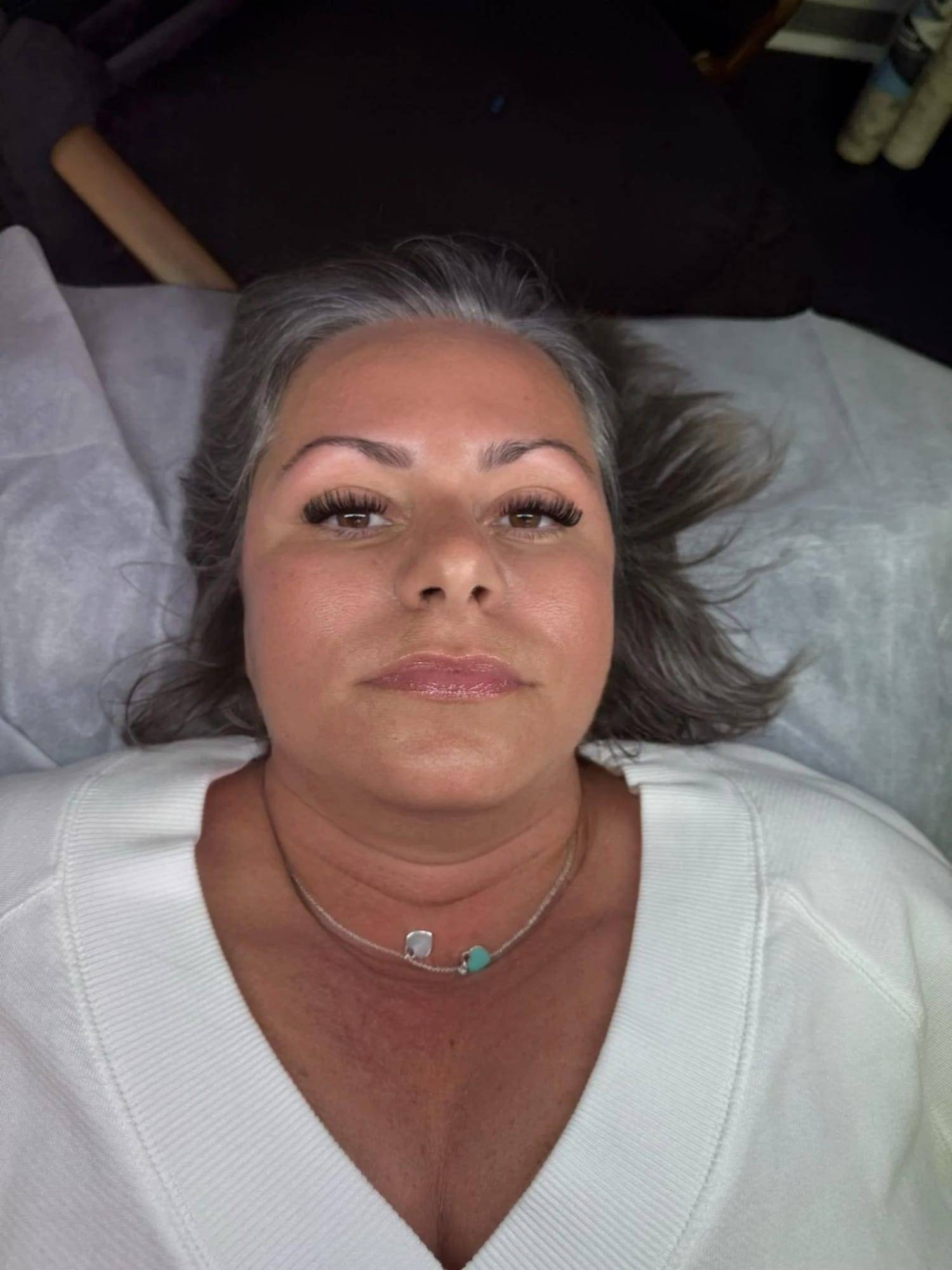 Client on the treatment bed after a lash and brow appointment