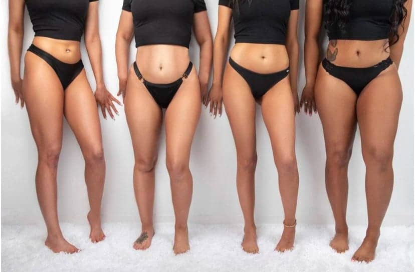 Four clients side by side showing natural-looking spray tan results across different skin tones